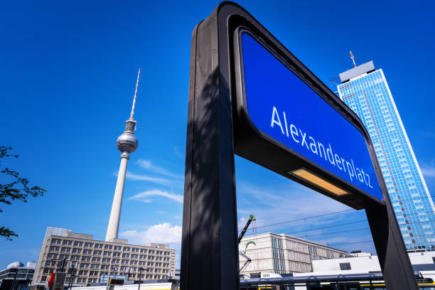 Sign of underground Subway Station Alexanderplatz: A bustling metropolitan hub with iconic landmarks, vibrant streets, and a modern urban atmosphere.\n\nTV Tower in the background