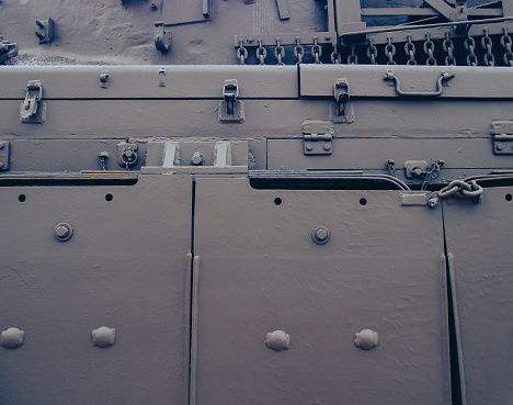 An extreme shot of a fixed battle tank track at an unknown location. For background.