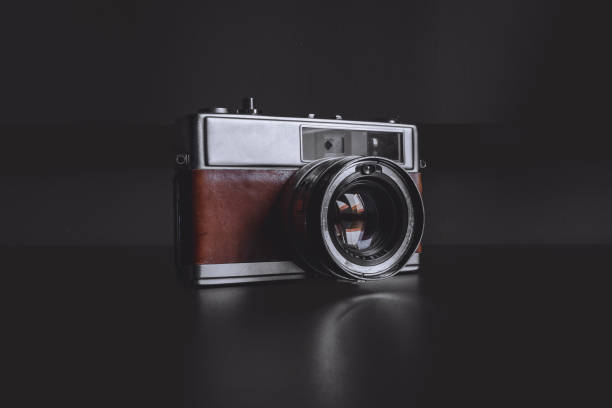istock Vintage film camera on dark background 1505804773