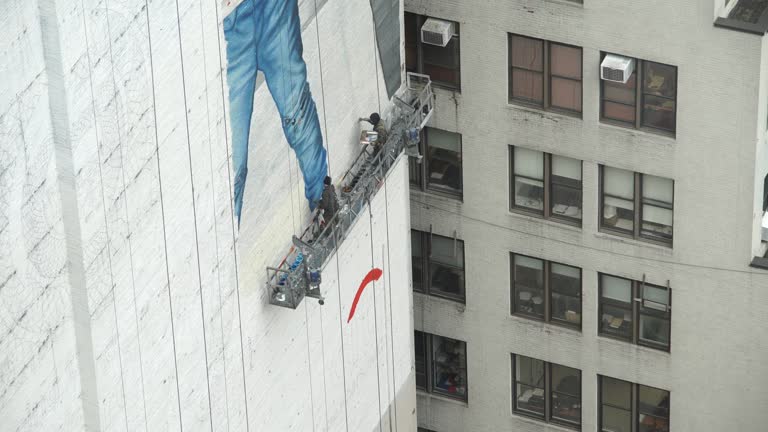 NEW YORK CITY - JAN 2019 - Wall painters working on scaffolding in Manhattan NYC