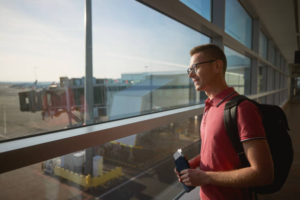istock Passenger looking through window at airport runway 1505815709