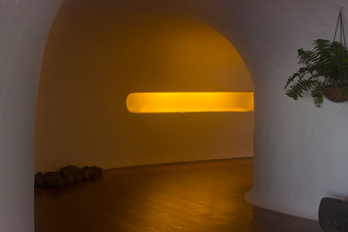 Illuminated curved corridor,  potted plant, traditional architecture in Lanzarote, Canary islands, Spain.