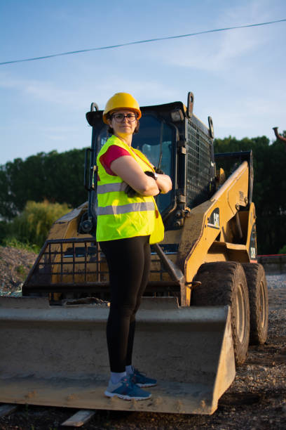 istock female construction worker driving earth mover 1505830924