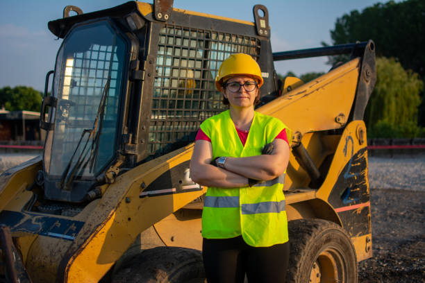 istock female construction worker driving earth mover 1505830926