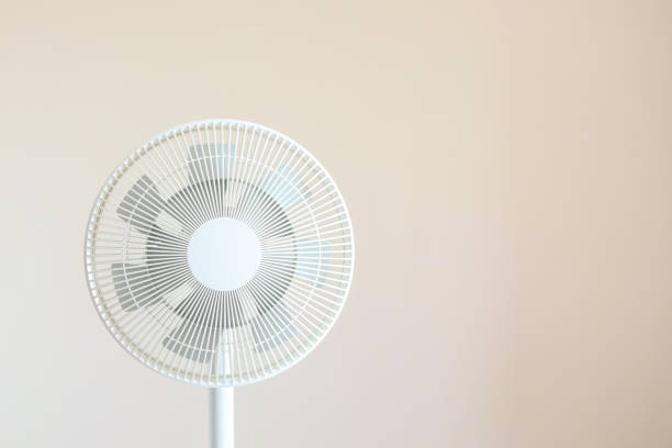 istock White desktop electric fan on light white background. Minimal concept with copy space 1505844027
