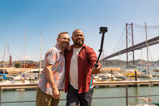 Gay couple taking a selfie on the Docas in Santo Amaro, Lisboa