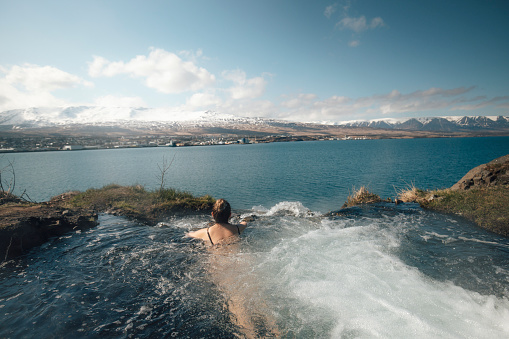 Woman relaxing in hot spring pool