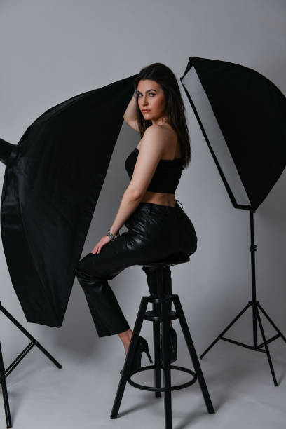 istock Studio Lights Focused On Beautiful Female Posing In Black Leather Clothing 1505853461