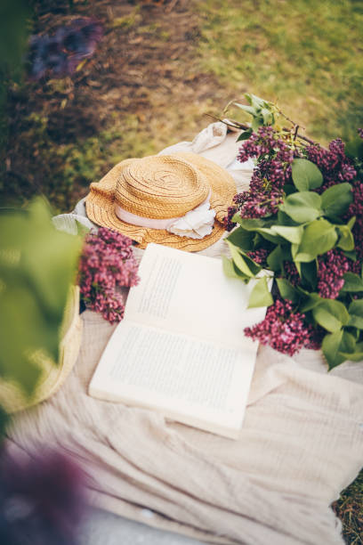 istock Open book in the grass on the field on sunny day in spring. Reading and knowledge concept 1505855102