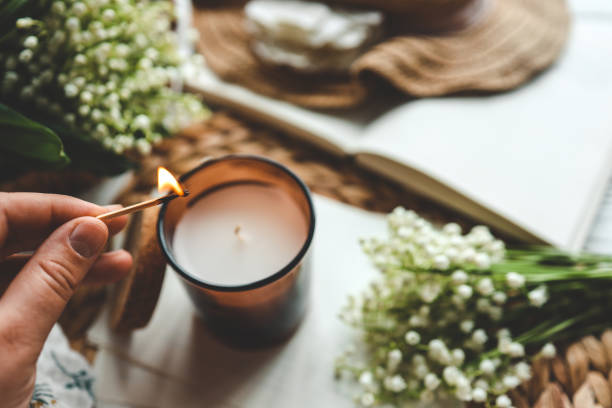 istock Match in hand lighting candles, aesthetics 1505865000