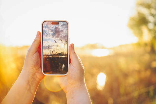 istock Girl photographing a beautiful sunset 1505865548