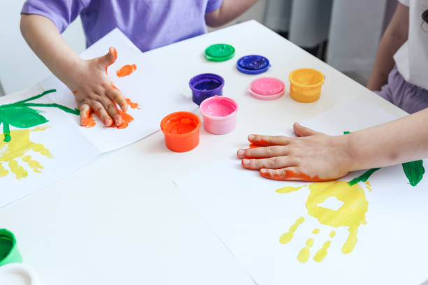 istock Children's drawing workshop, happy children make handprints with paint. 1505881327