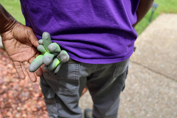 A black man with a pair of work gloves in his back pocket