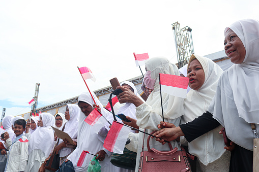 Female congregation waiting for President Jokowi's arrival during the kick-off implementation of recommendations for non-judicial resolution of 12 cases of gross human rights violations in the past, at Rumoh Geudong, one of the former Tactical and Strategic Unit Posts (Pos Sattis) in the A-Pidie Sector during implementation of the Military Operations Area (DOM) in Aceh (1989-1998), located in Gampong Bili Aron, Glumpang Tiga District, Tuesday, 27 June 2023.