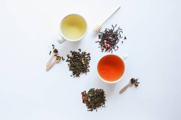 istock Herbal leaf dried tea and cups with drink, top view on white background 1505907307