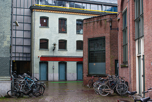 bicycles parked in front of buildings during rainy day