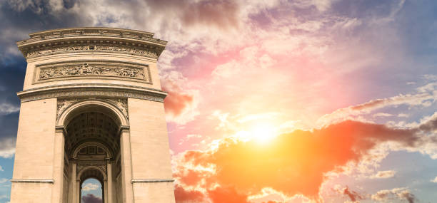 Arc de Triomphe (against the background of a sky at sunset), Paris, France. The walls of the arch are engraved with the names of 128 battles and names of 660 French military leaders (in French) Arc de Triomphe (against the background of a sky at sunset), Paris, France. The walls of the arch are engraved with the names of 128 battles and names of 660 French military leaders (in French) names of marbles stock pictures, royalty-free photos & images