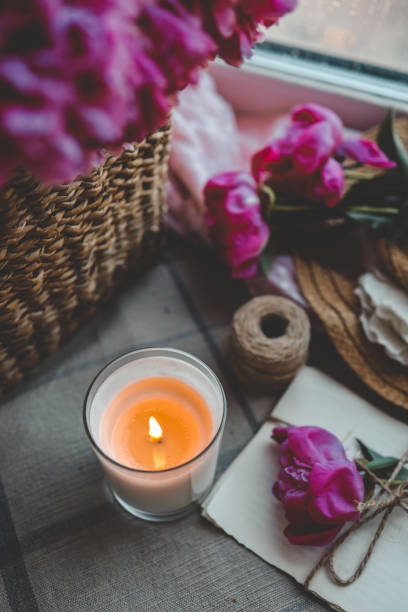 istock Burning candle and pink peonies, vintage aesthetic 1505956183