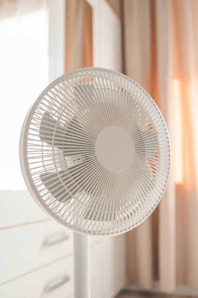 istock White desktop electric fan on light white room. Minimal concept with copy space 1505966041