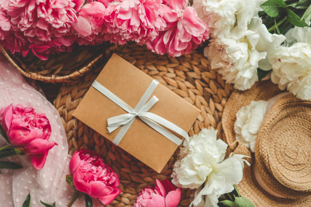 istock Gift box with bow and pink peonies, holiday concept 1505966057