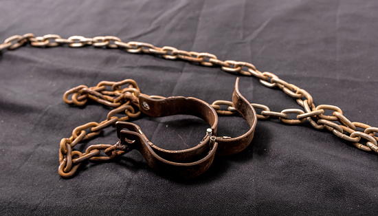 Old chains or handcuffs used to hold prisoners or slaves between 1600 and 1800.