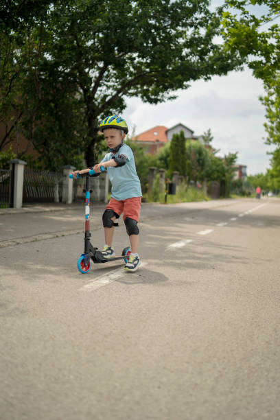 istock Little boy riding scooter. Kids ride kick board 1506007078