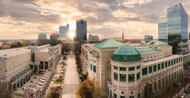 North Carolina State Capitol and Raleigh skyline at sunset.