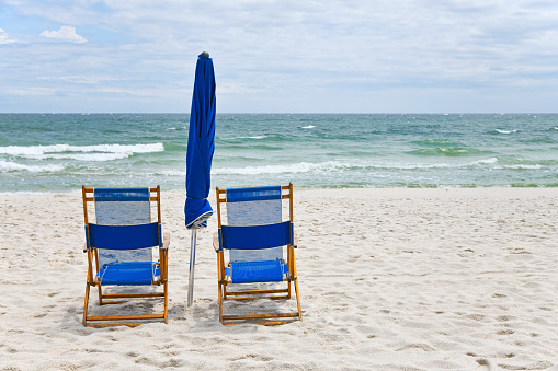 Blue Beach Chairs with Umbrella on White Sand Beach