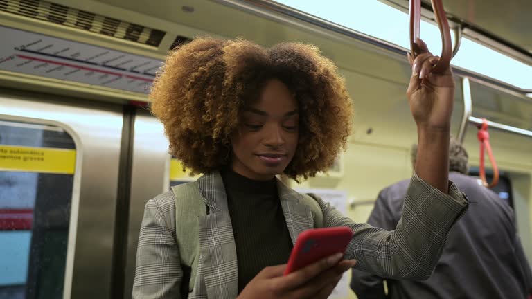 A woman using her cell phone inside the metro