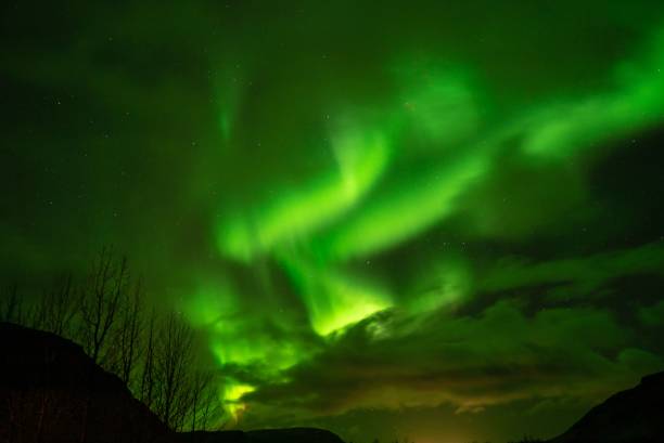 istock Stunning night sky view of a green, illuminated Aurora Borealis waves 1506139544