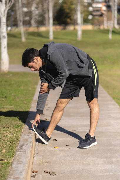 istock Attractive athletic man doing stretching exercise, preparing for morning workout in the park 1506147691