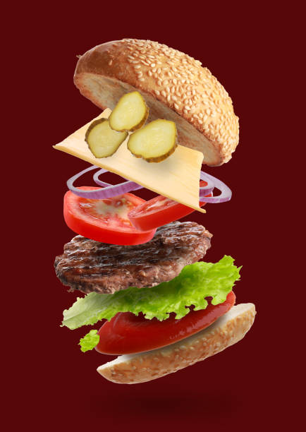 istock Delicious burger with different flying ingredients on dark red background 1506160999