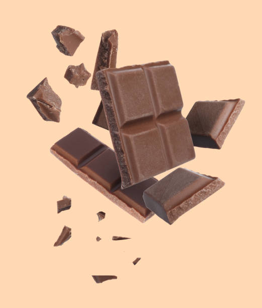 istock Pieces of chocolate bar falling on beige background 1506161022