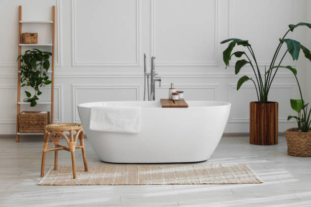 istock Stylish bathroom interior with beautiful tub, stool and houseplants 1506167535