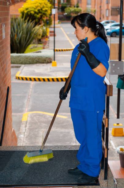 cleaning woman sweeping the building halls and copy space stock photo