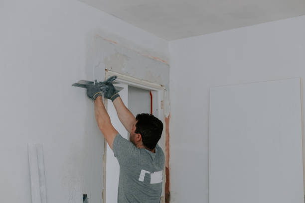 istock One young man is plastering a doorway. 1506255381