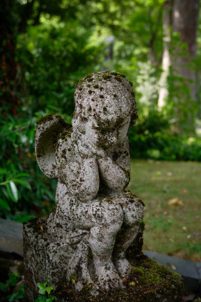 istock mossy putto sitting on a grave 1506259811