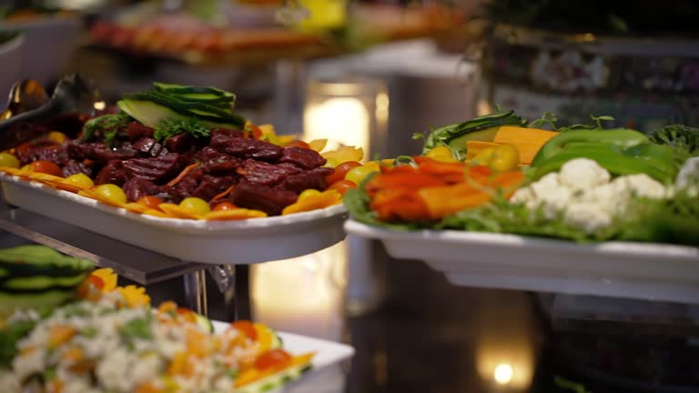 Food service worker cuts a slice of ham, Catering for wedding events. move camera