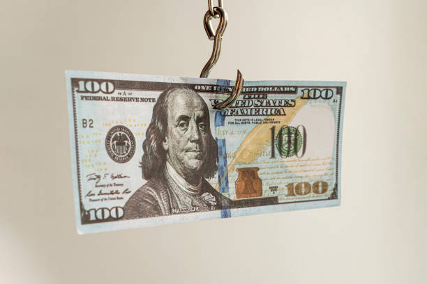 uzależnienie od koncepcji dolara. dolar amerykański na haczyk na ryby - buyer beware zdjęcia i obrazy z banku zdjęć