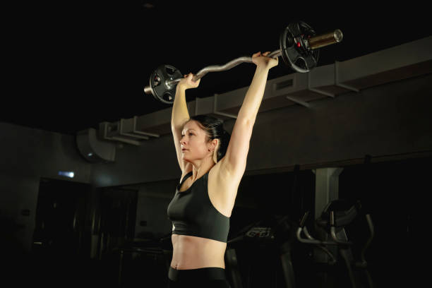 istock woman training with heavy barbell in modern gym 1506275934