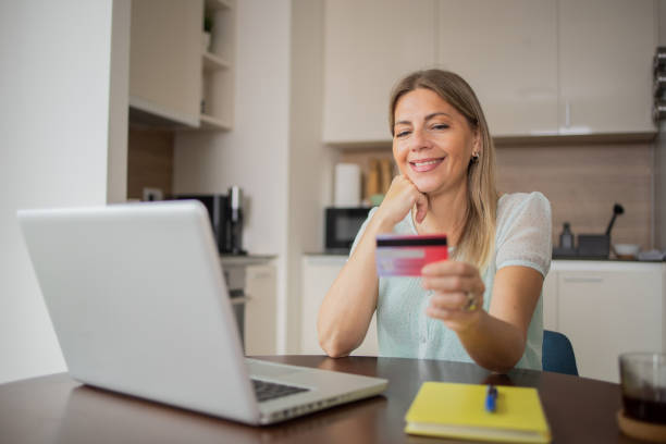 istock Cheerful  woman doing online shopping 1506284658