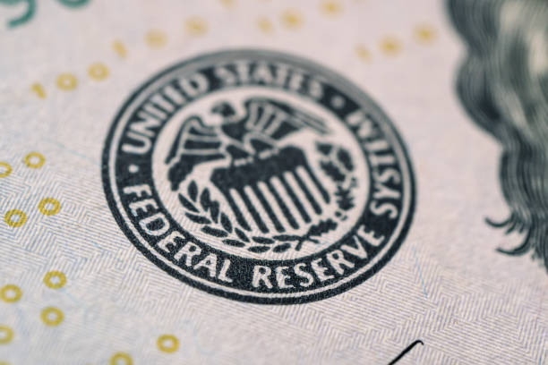 istock Selective focus on US Federal Reserve emblem on hundred dollars banknote as FED consider interest rate hike, economics and inflation control national organization. 1506287490