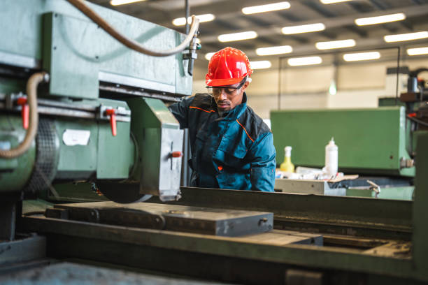 istock Male Factory Worker Operating An Industrial Machine 1506288037
