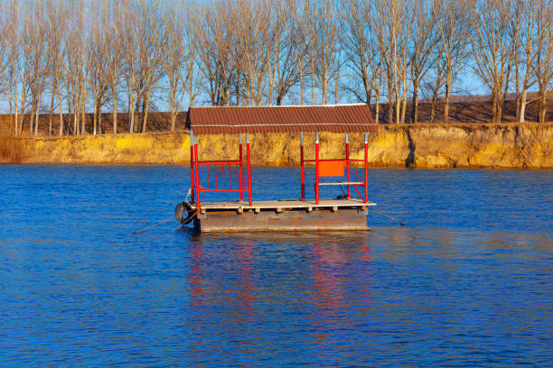 Fishing boat on the river in early spring with blue sky background
