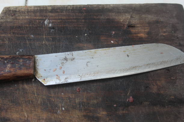 istock dirty kitchen knives on a wooden cutting board 1506348960