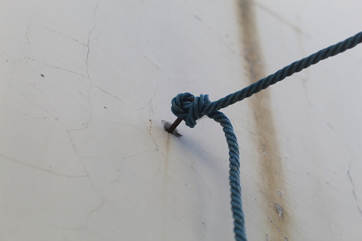 close up of a blue rope on white background