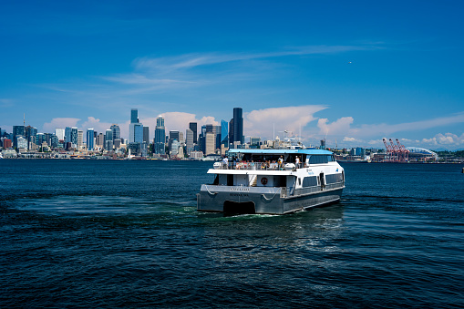 West Seattle WA, USA - June 25, 2023: People ride the Water Taxi from West Seattle Seacrest Park to the Downtown Seattle waterfront on a warm sunny day.