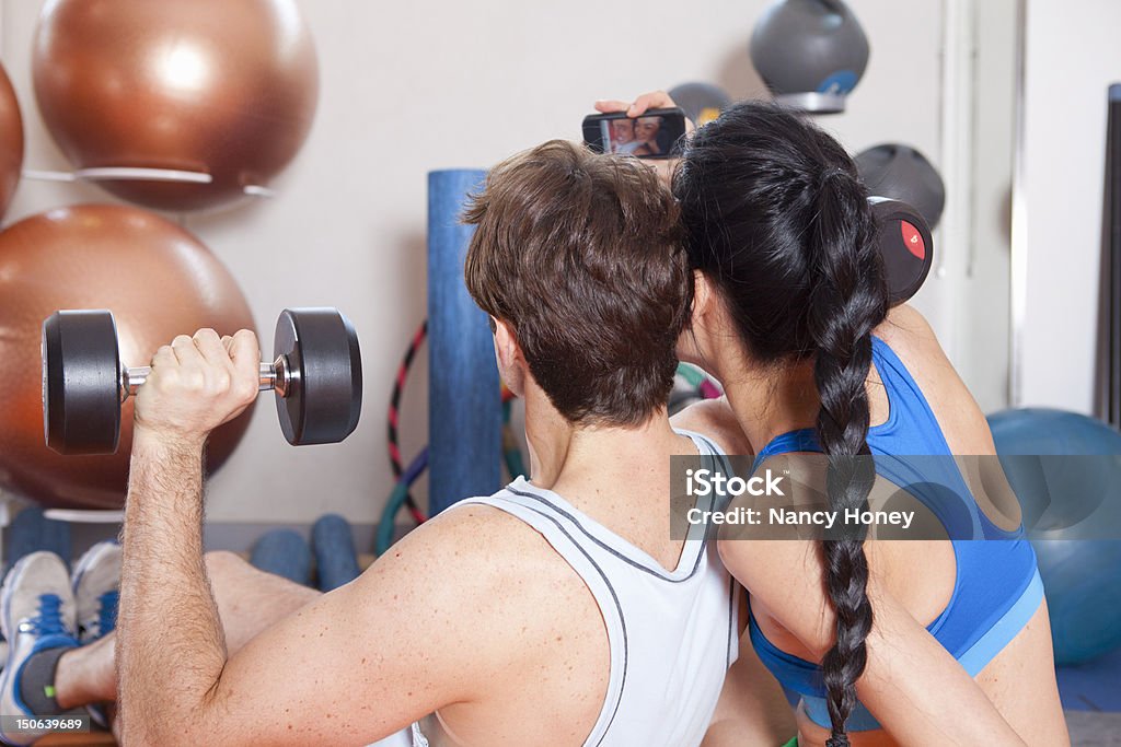 Couple taking picture together in gym  Health Club Stock Photo