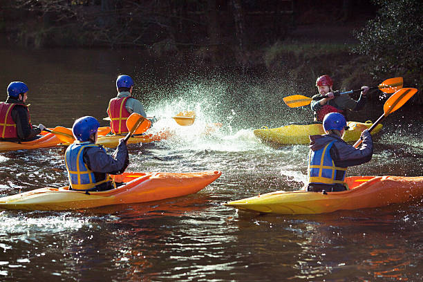 Kayakers rowing together on still lake  aquatic sport stock pictures, royalty-free photos & images