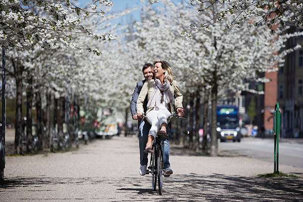 man riding con novia en bicicleta - urban scene women adventure city fotografías e imágenes de stock